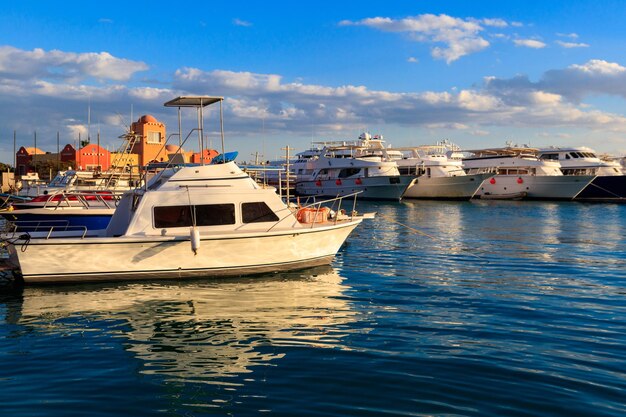 White yachts in the sea harbor of Hurghada Egypt Port with tourist boats on the Red Sea