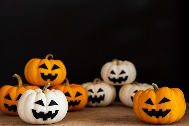 White and yellow ghost pumpkin on black background. halloween concept. 