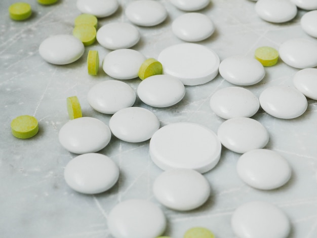 White and yellow pills on white background.