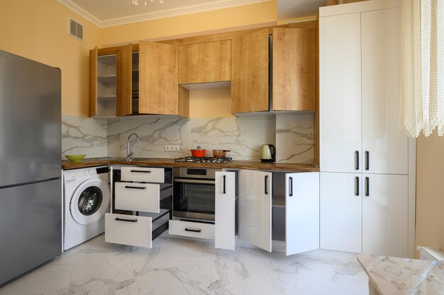 White and yellow wooden modern kitchen interior some drawers open