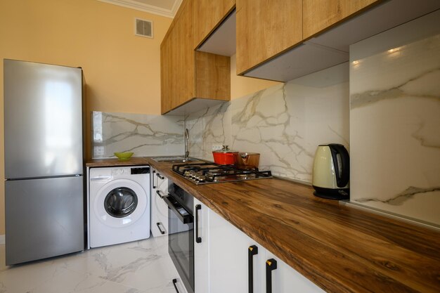 White and yellow wooden modern kitchen interior