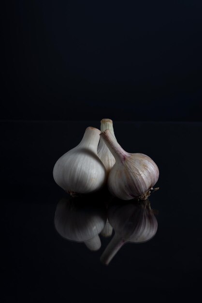 White young garlic on a black background minimalistic