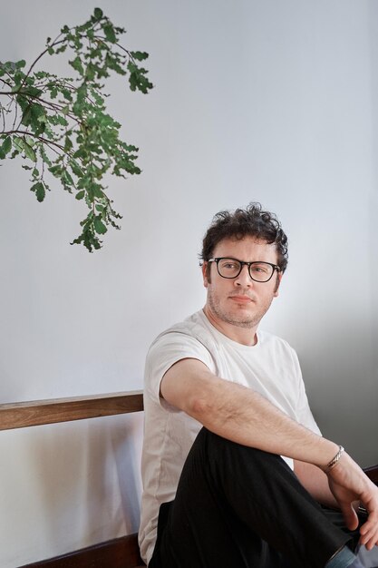 White young man sit on floor looking pensive