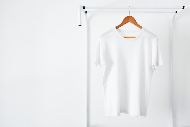 Whitet-shirt hanging on wooden hanger