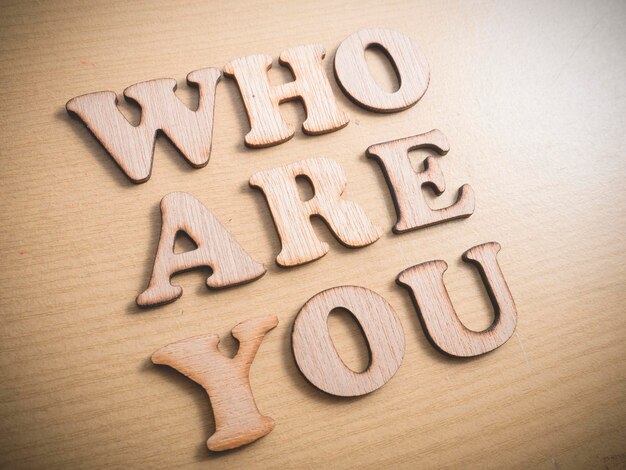 Photo who are you in wooden words letter motivational self development business typography quotes concept