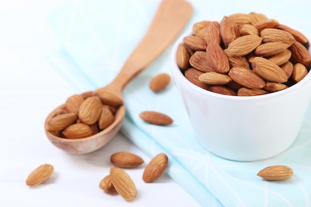 Whole almonds on the table on a light background closeup