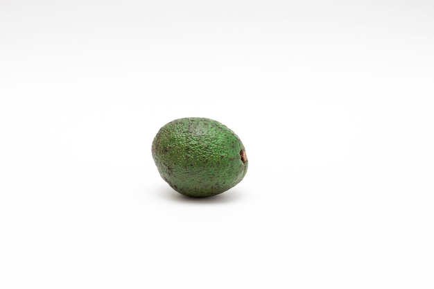 Whole avocado on a white background