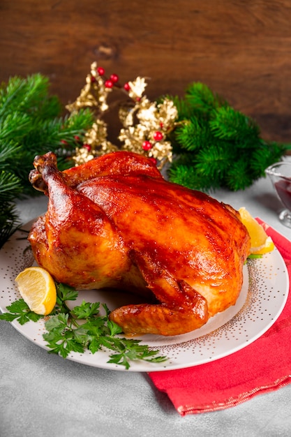 Whole baked chicken in sauce with paprika on a plate