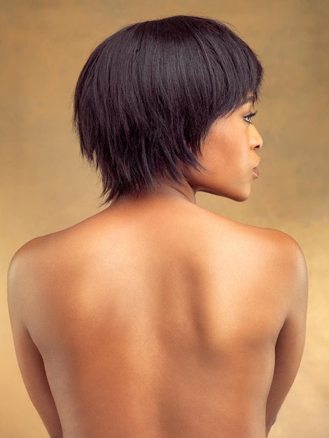 Whole body perfection Rearview studio shot of a beautiful young woman against a brown background