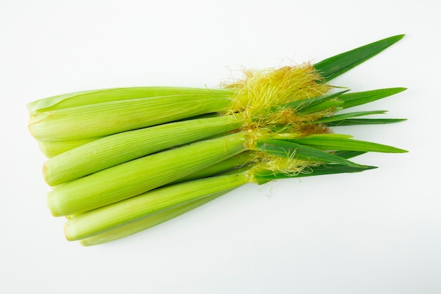 A whole bunch of baby corn on white background