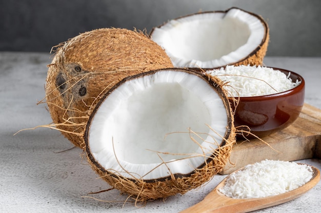 Whole coconut pieces of coconut and shredded coconut on the table