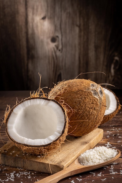 Whole coconut pieces of coconut and shredded coconut on the table