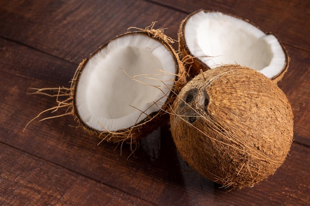 Whole coconut and pieces of coconut on the table
