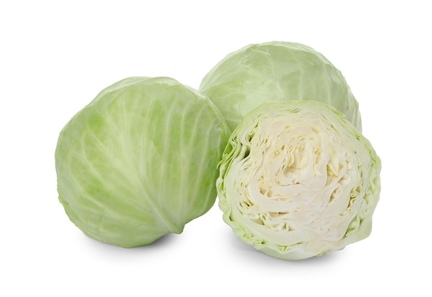 Whole and cut fresh ripe cabbages on white background