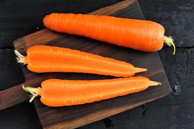 Whole and cut in half carrot close-up