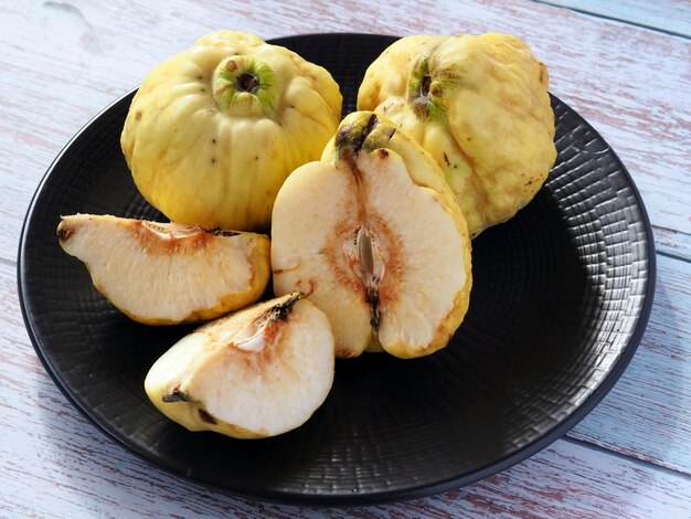 Photo whole and cut into half and slices of quince fruit