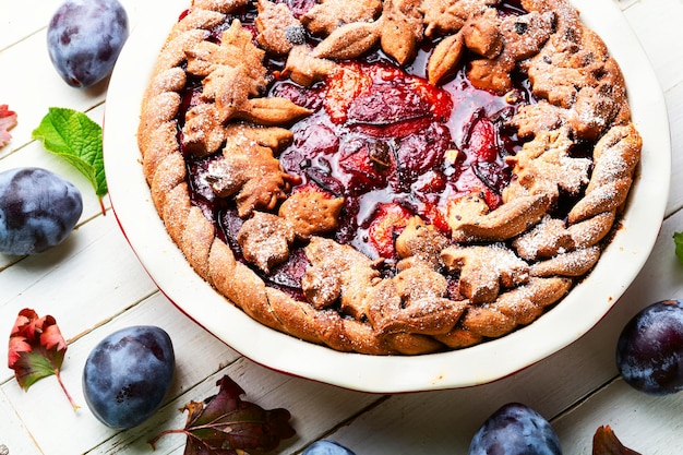 Whole delicious pie with autumn plum.Fruit summer pastries