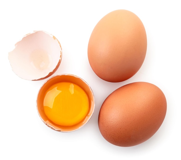 Whole eggs, half and shells close up on a white background, isolated. Top view