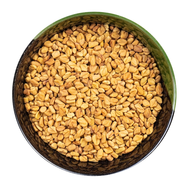 Photo whole fenugreek seeds in round bowl isolated