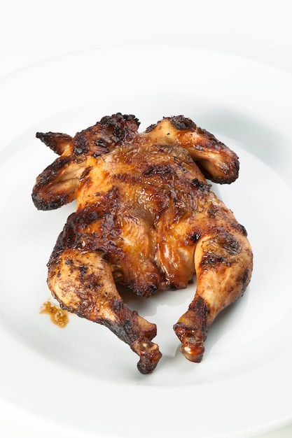 whole fried chicken on a wooden cutting board