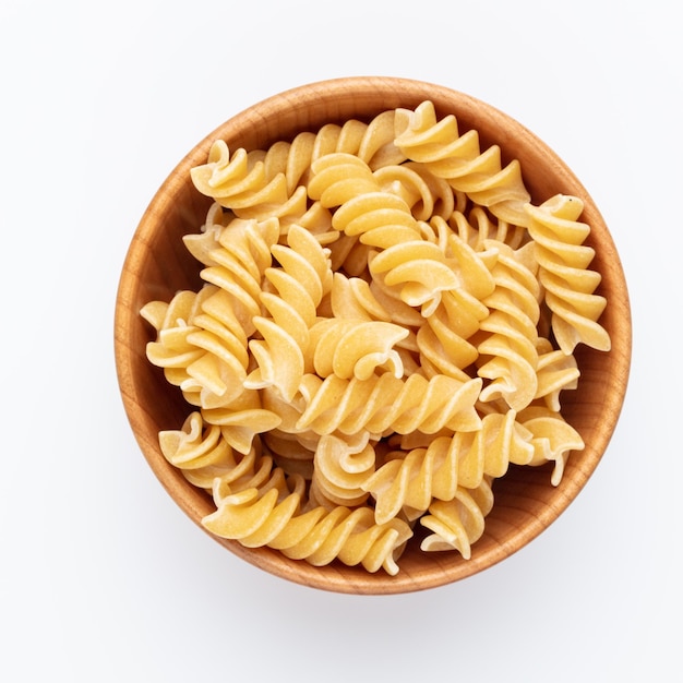 Whole fusilli pasta in a wooden bowl