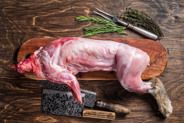 Whole game hare raw meat on wooden old rustic table Wooden background Top view