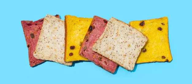 Whole grain bread slices on blue background