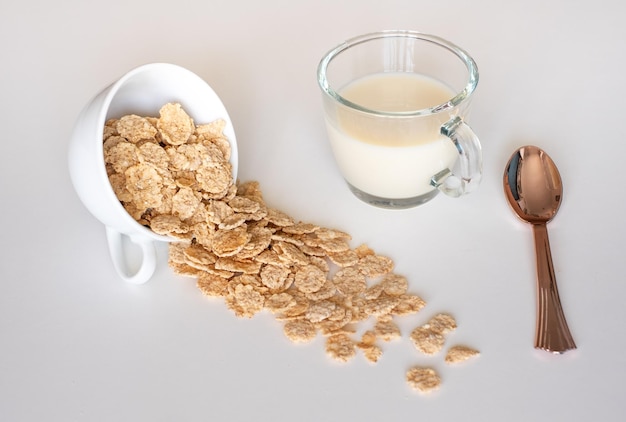 Whole grain cereal flakes in bowl Wholegrain breakfast cereals isolated on a white background