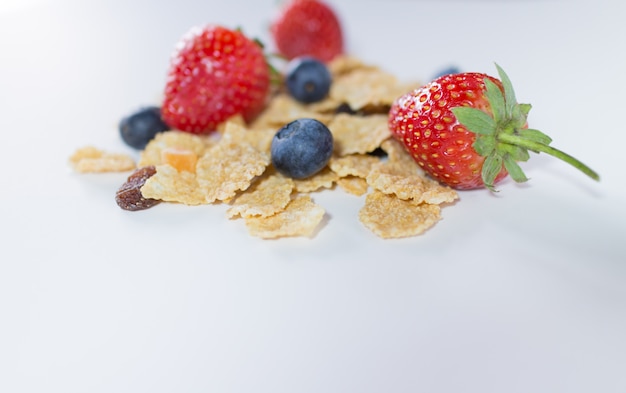 Whole grain cereal flakes which mixed berry fruit and raisins