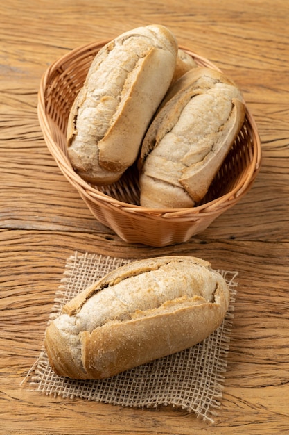 Whole grain french bread salt bread or pistolet on a basket over wooden table