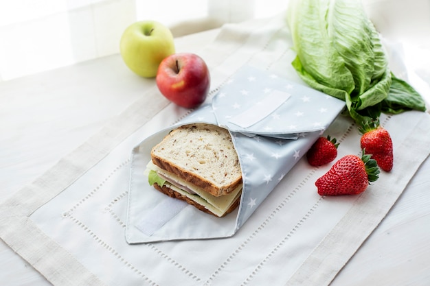 Whole grain sandwich wrapped in reusable bag Zero waste ecologic concept