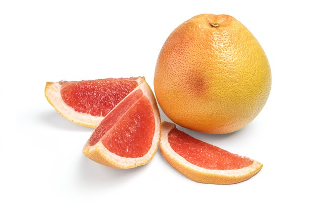 Whole grapefruit and wedges isolated on white.