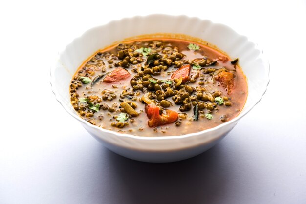 Whole Green Moong Dal fry or Whole Mung bean Tadka served in a bowl. selective focus