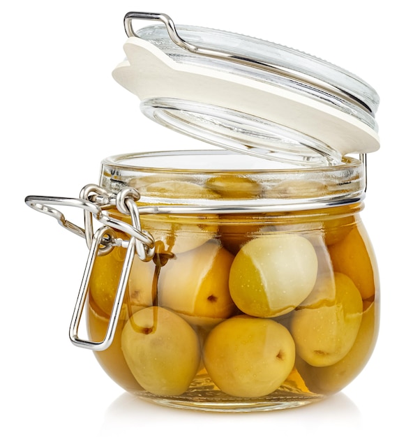 Whole green olives in brine in open transparent glass jar isolated on white