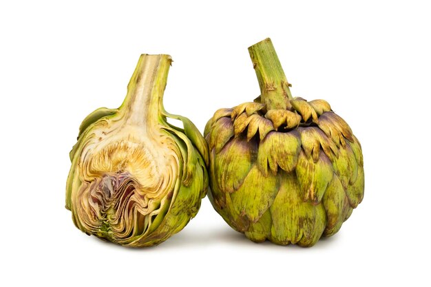 Whole and half artichoke on isolated white background