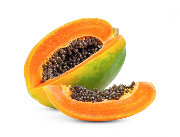 Whole and half ripe papaya on white table. 