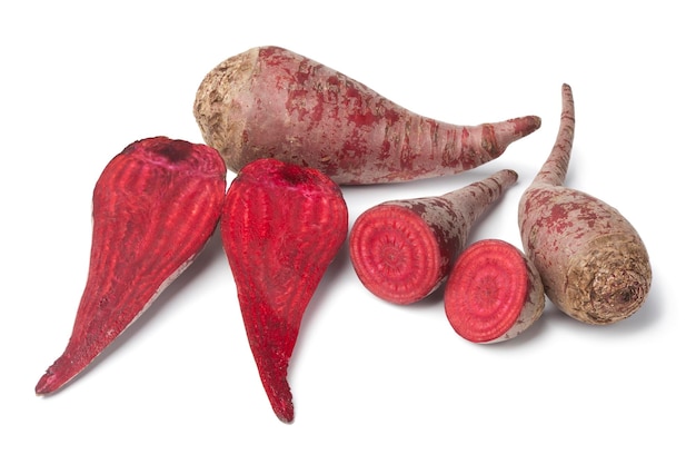 Whole and halved organic red beets isolated on white background close up