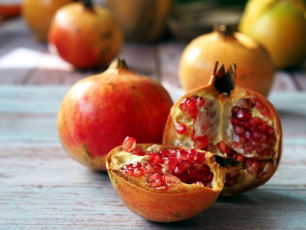 Whole and halved pink pomegranates