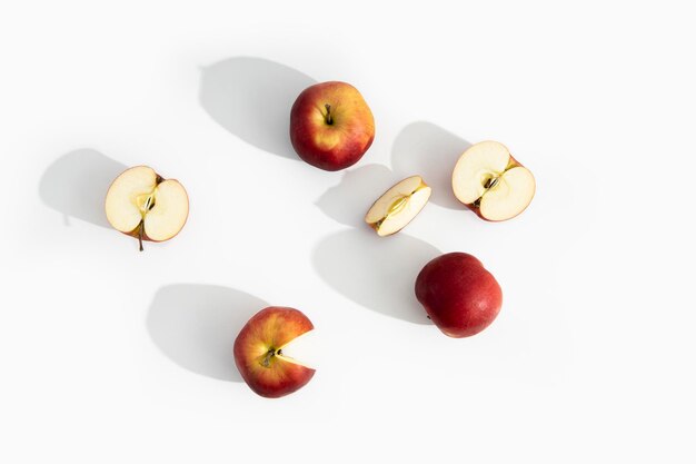 Whole halves and cut apples on a white background Top view flat lay