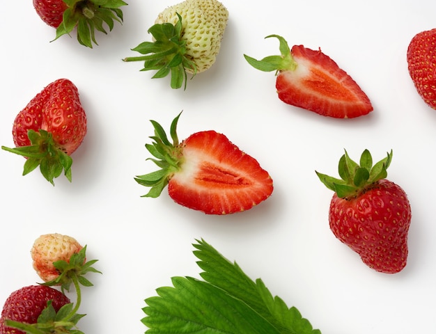 Whole and halves of fresh ripe red strawberries