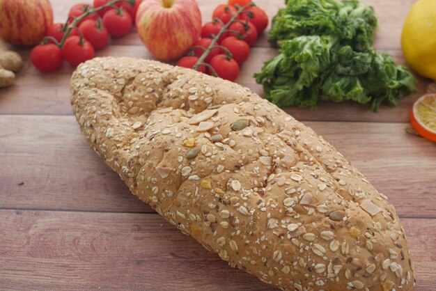 Whole meal bread apple and cherry tomato on table