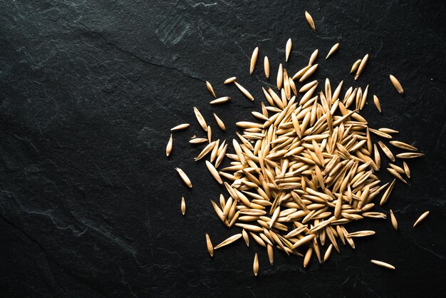 Photo whole oats for germination on a stone table