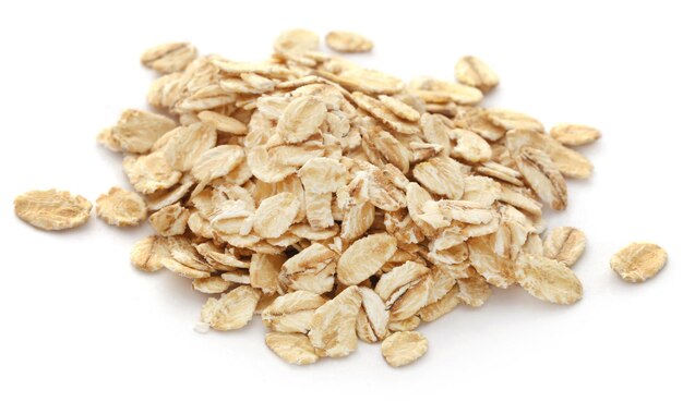 Whole oats in a pile over white background