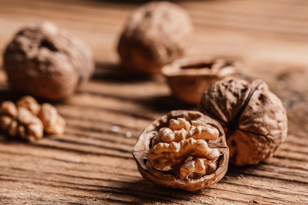 Whole and open walnuts with walnut grain on a wooden table Fruit healhy oraganic raw snack food nuts kernels