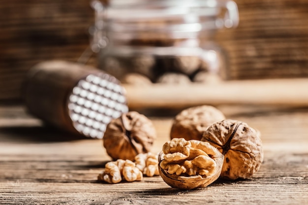 Whole and open walnuts with walnut grain on a wooden table Fruit healhy oraganic raw snack food nuts kernels