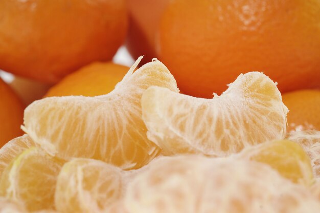 Whole orange fruits and peeled segments 