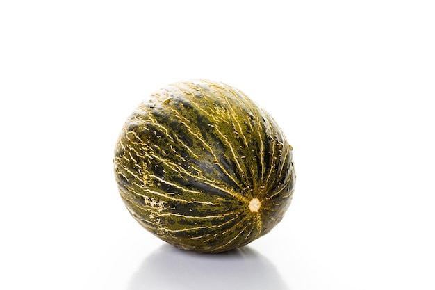 Whole organic Piel de Sapo melon on a white background.