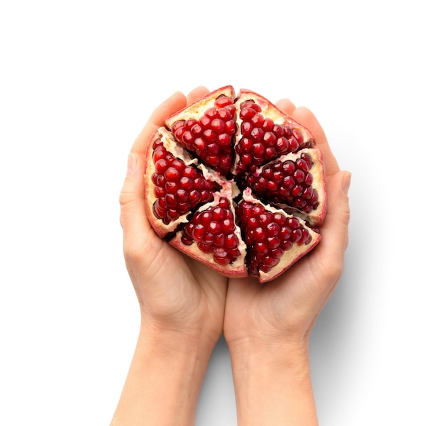 Whole peeled pomegranate in hands on white background