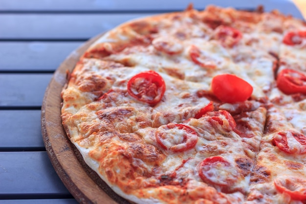 Whole pizza Margarita with tomatoes and cheese. 