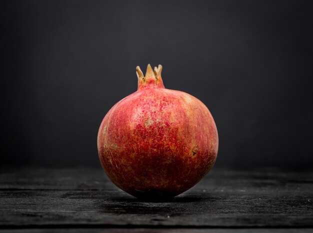 whole pomegranate on black background